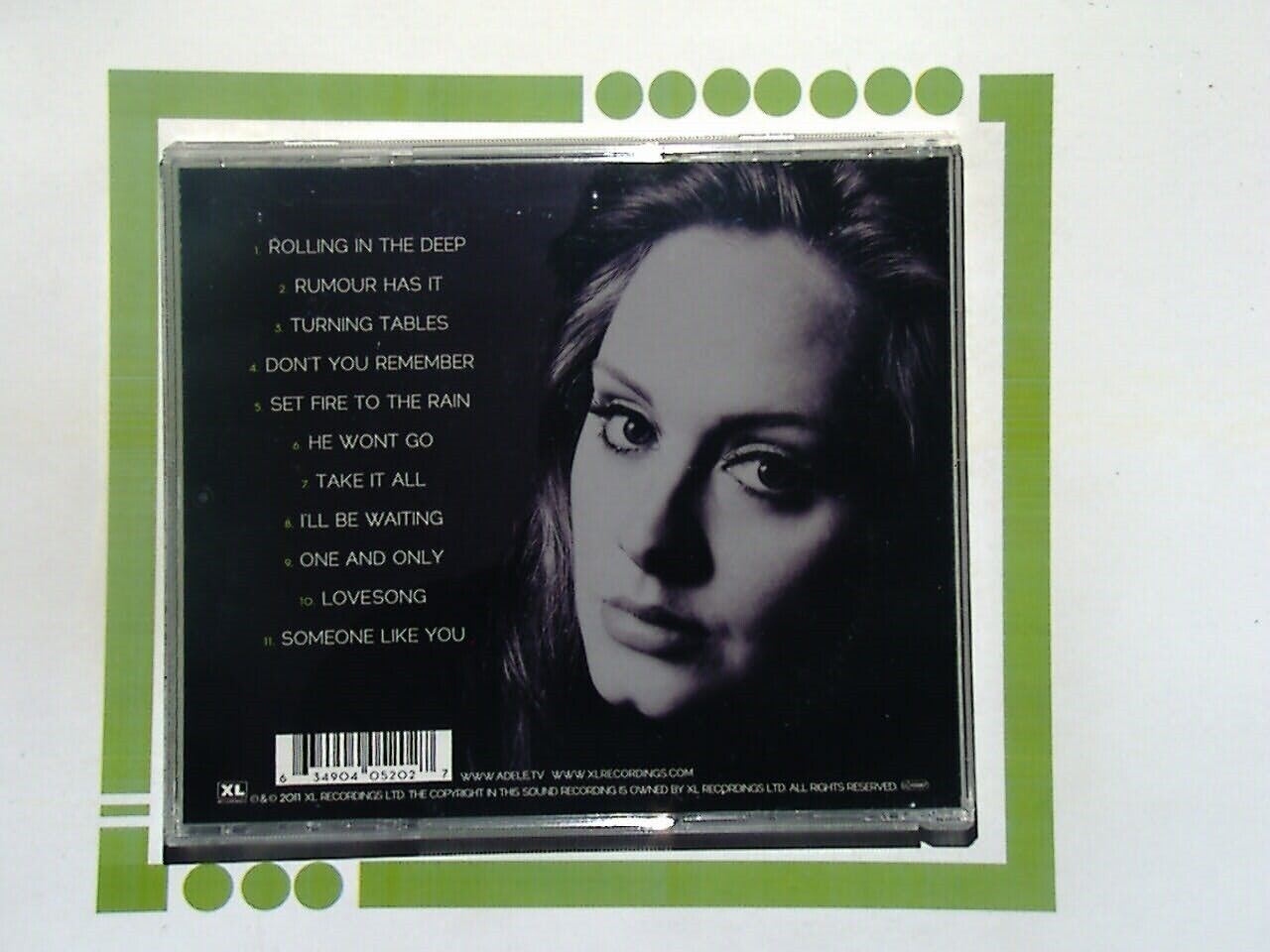 Bookandbeat.com CD: Adele - 21, Pop Music, Grammy Award-Winning Album, Sophomore Studio Release, Soulful Vocals, Emotional Ballads, Chart-Topping Hits, Personal Themes, Production by Rick Rubin and Paul Epworth, Iconic Tracks, "Rolling in the Deep," "Someone Like You," "Set Fire to the Rain," Heartfelt Lyrics, Powerful Storytelling, Contemporary Sound, Cultural Impact, Critical Acclaim, Multi-Platinum Sales, Influential Artist, Essential Listening for Music Lovers, Richly Arranged, Timeless Classics, Music