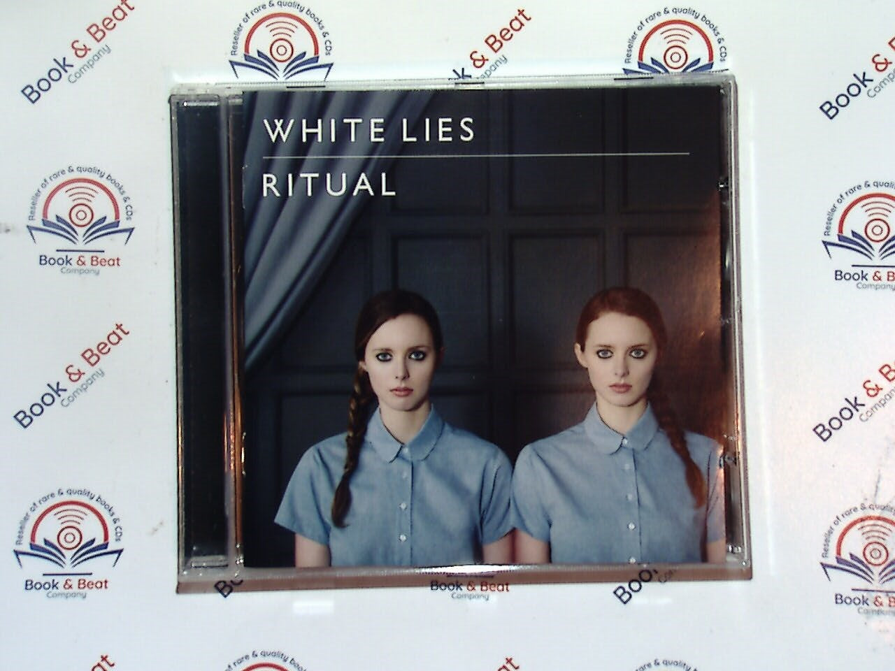 bookandbeat.com, White Lies, Ritual, alternative rock, post-punk revival, British band, dark melodies, atmospheric sound, 2011 release, synth-infused rock, emotional lyrics, indie rock, haunting vocals, powerful rhythms, critically acclaimed, modern gothic, dramatic arrangements, introspective themes, moody soundscapes, must-listen album, cinematic music, layered production.