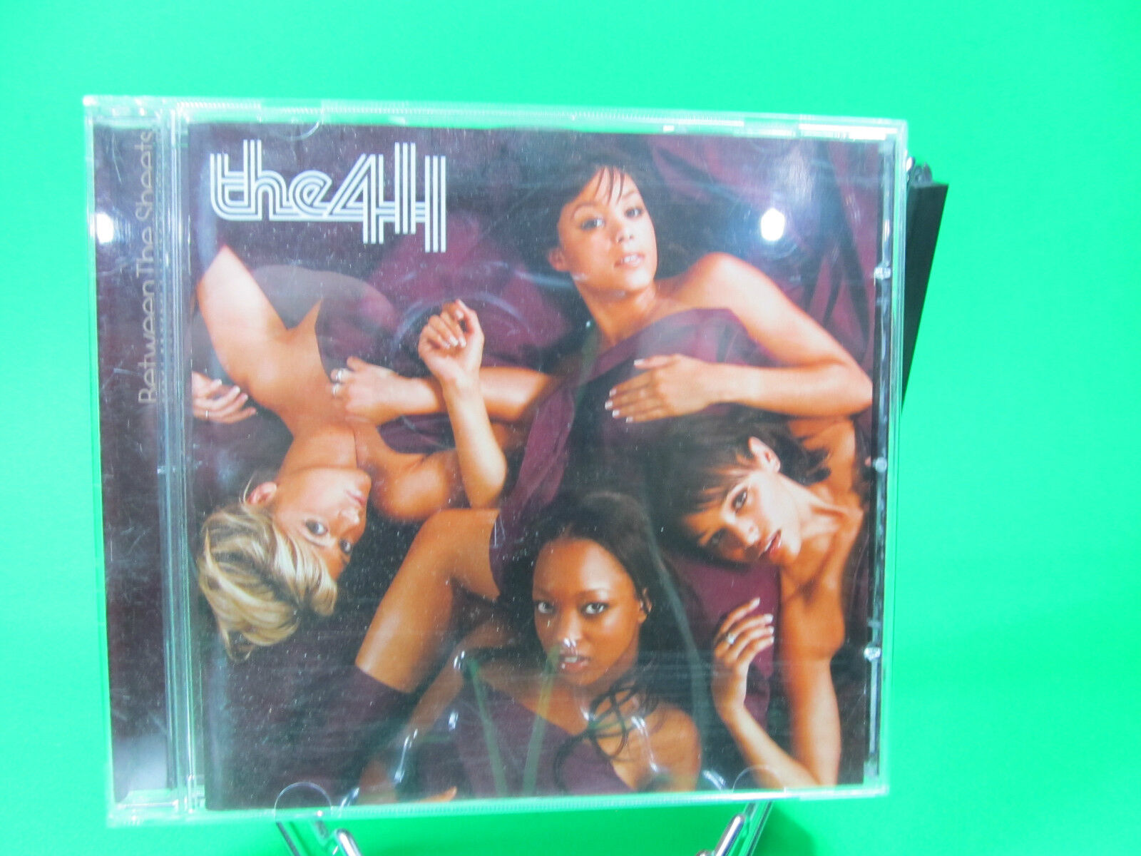 The 411, Between The Sheets album, R&B group, pop music, bookandbeat.com, British R&B, girl group, contemporary R&B, urban music, smooth vocals, soulful tunes, early 2000s music, hit singles, dance-pop, catchy beats, love songs, female vocalists, chart-toppers, UK music, modern R&B, pop-R&B fusion,