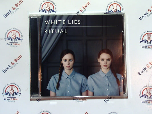 bookandbeat.com, White Lies, Ritual, alternative rock, post-punk revival, British band, dark melodies, atmospheric sound, 2011 release, synth-infused rock, emotional lyrics, indie rock, haunting vocals, powerful rhythms, critically acclaimed, modern gothic, dramatic arrangements, introspective themes, moody soundscapes, must-listen album, cinematic music, layered production.