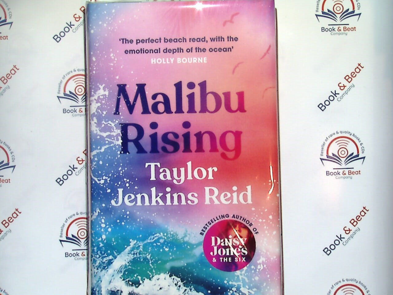 Taylor Jenkins Reid, Malibu Rising, new hardback, bestselling author, contemporary fiction, family drama, beach read, 80s California, sibling relationships, celebrity culture, summer book, Malibu setting, emotional storytelling, literary fiction, popular novel, Bookandbeat.com, New York Times bestseller, page-turner, novel of the year, California coast, family secrets, new release.