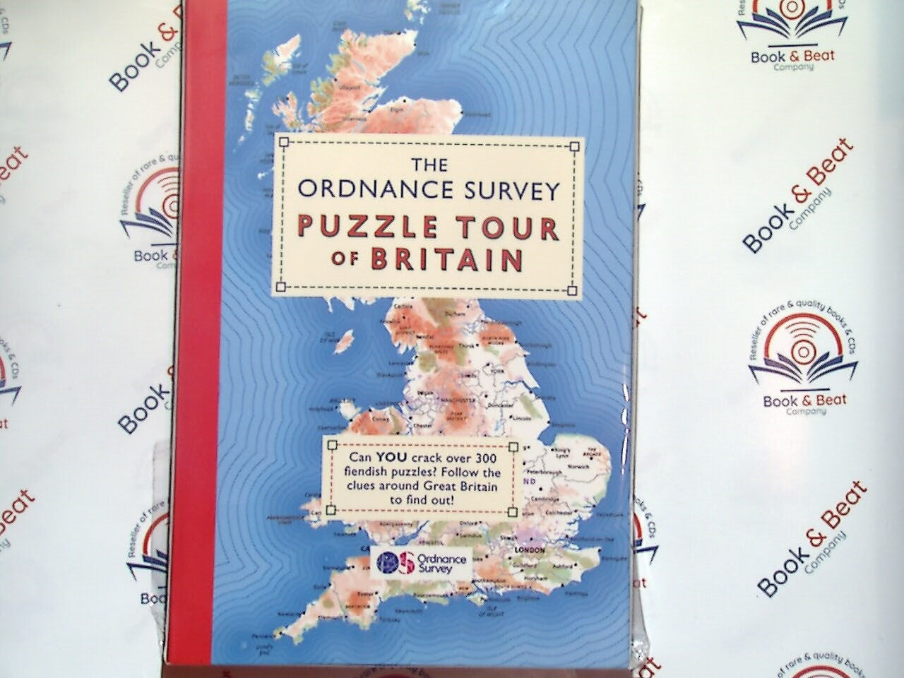 The Ordnance Survey Puzzle Tour of Britain, puzzle book, geography quiz, travel puzzle, British landmarks, Ordnance Survey, map puzzles, UK travel, Bookandbeat.com, British geography, interactive puzzles, sightseeing, brain teasers, travel challenge, educational puzzles, fun quizzes, British history, travel trivia, exploration, unique puzzles, interactive learning, adventure through puzzles.